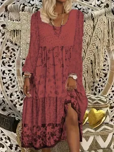 Elegant long-sleeved printed maxi dress featuring a round neckline and boho patterns.
