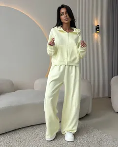 Detailed view of women's cream-colored zip-up hoodie and wide-leg cotton tracksuit set