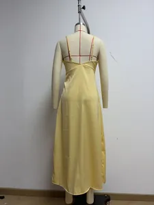 Back view of a sleek yellow satin slip maxi dress on a professional mannequin form