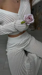 Close-up of elegant white open-knit crochet texture on high-waisted loungewear set