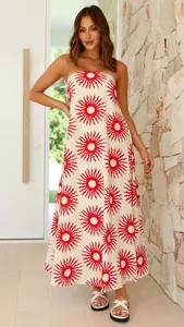 Close-up detail showing the vibrant red sunburst print on this strapless maxi vacation dress
