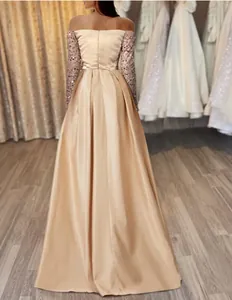 Elegant champagne off-shoulder sequin long sleeve evening gown detail from behind