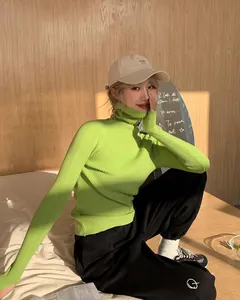 Close-up of lime green ribbed turtleneck sweater showing slim fit and soft knit texture