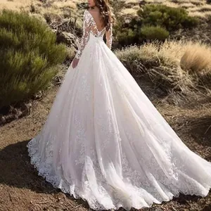 Elegant long sleeve lace wedding dress featuring an open back and grand floor-length train