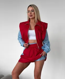 Detailed shot of a two-piece red and blue color-block tracksuit with a zip-up top