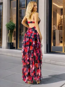 Back view of an elegant floral chiffon evening gown with ruffle details and backless design