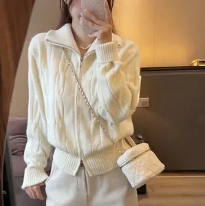 Stylish white cable-knit cardigan with double zippers shown in a casual mirror selfie