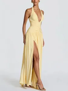 Elegant light yellow halter neck maxi dress featuring a deep V-neck and high side slit.