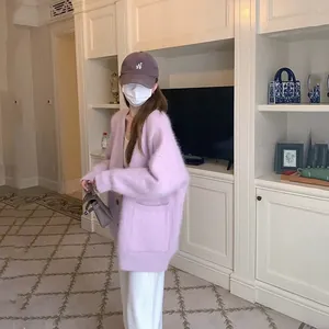 Woman wearing a stylish lavender oversized fuzzy mink-like cardigan in a cozy indoor setting