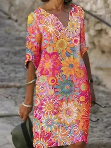 Detailed view of women's colorful floral print V-neck dress with abstract patterns.