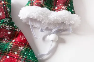 Close-up of pet Christmas cloak with adjustable drawstring and soft white fleece trim.