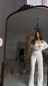 Elegant white hollow knit two-piece set with cropped cardigan and wide-leg trousers