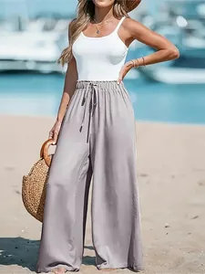 Elegant high-waisted wide-leg pants for women styled for beach vacation