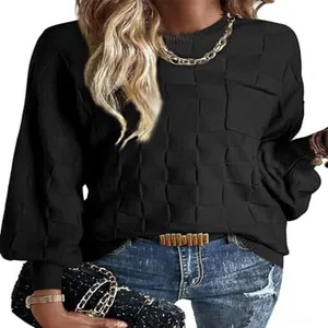 Close-up detail of women's black sweater showing the unique block textured knitting