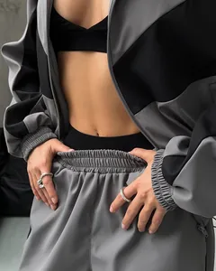 Detail view of women's stylish grey and black color-block loose fit sporty tracksuit set