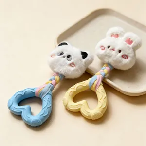 Detailed view of two plush dog squeaky toys with panda bunny heads and heart-shaped teethers