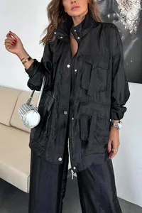 Detail of a black oversized utility jacket with large functional pockets