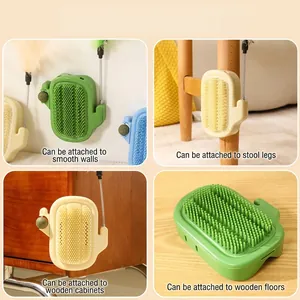 Cactus-shaped cat self-groomer brush with teaser stick and catnip for wall mounting.