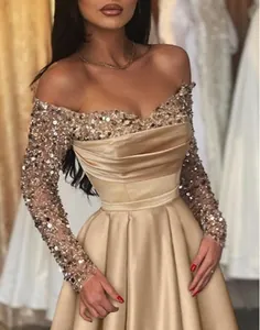 Elegant champagne gold evening gown with shimmering sequins and smooth satin finish.