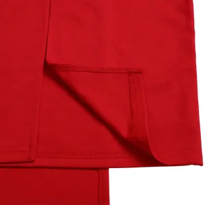 Close-up view of clean double-needle stitching and slit on red fabric hemline detail