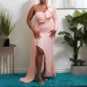 Full view of a pink sequin evening gown showing the one-shoulder and high slit detail