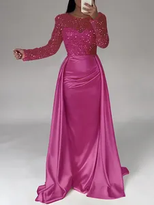 Elegant fuchsia long-sleeve evening gown with sequined bodice and satin draped skirt.