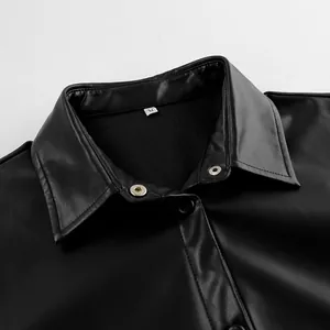 Close-up detail of black PU leather jacket collar showing fine texture and size tag