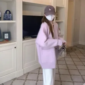 Detailed view of oversized lavender faux mink cardigan on model in indoor setting
