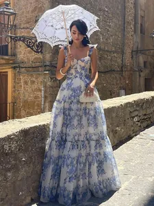 Elegant white and blue floral organza long evening dress in a vintage outdoor setting