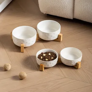 White ceramic pet bowl set with paw prints and bamboo stand for cats and small dogs