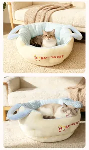 Detailed view of the cozy striped cat bed featuring soft handles and plush lining