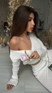Close-up of a stylish white sheer hollow-out knit two-piece set featuring off-shoulder top