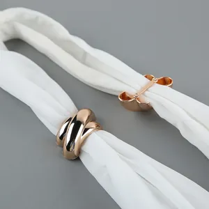 Close-up detail of the golden metal buckle on an elegant white chiffon halter neck top