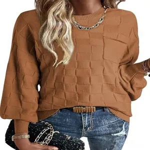 Close-up detail of a brown checkered knit sweater showing the 3D grid textured pattern