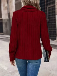 Back view of a cozy red ribbed knit turtleneck sweater styled with jeans on a street.