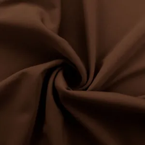 Macro view of dark brown high-stretch fabric for women's athletic yoga pants.