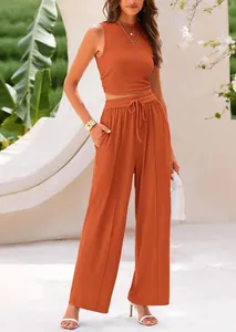 Fashionable burnt orange two-piece knit set featuring sleeveless top and wide-leg trousers