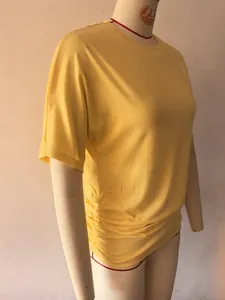 Detailed side view of yellow slim fit women's T-shirt featuring elegant ruched texture