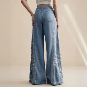 Bohemian style high-waist wide-leg jeans featuring delicate white floral embroidery