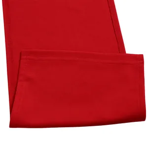 Detailed close-up of a red fabric hem with high-quality stitching on a chic office dress