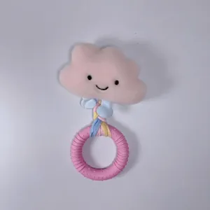 Dettaglio di un gioco in peluche rosa a forma di nuvola con anello massaggiagengive.