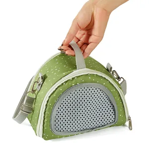 Portable green polka dot carrier bag for small pets featuring a breathable mesh window
