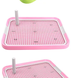 Detail shot of large pink dog training toilet with removable pillar and mesh grid tray.