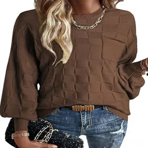 Close-up of brown textured knit sweater with round neck and long sleeves.