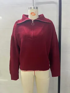 Close-up of burgundy oversized knit sweater with half-zip collar on mannequin