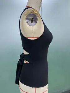 Close-up detail of a black slim-fit sleeveless top with side cutout and back bow