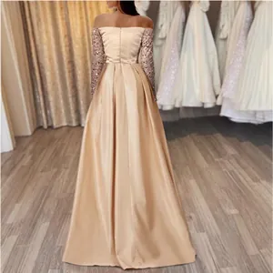 Elegant champagne gold off-the-shoulder evening gown with sequined long sleeves and satin skirt