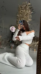 Elegant woman in chic white knitted two-piece set with hollow-out design for summer