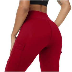Detailed macro view of the side cargo pocket on red high-waisted yoga pants for women