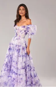 Detailed view of an elegant off-the-shoulder evening gown with purple floral organza patterns